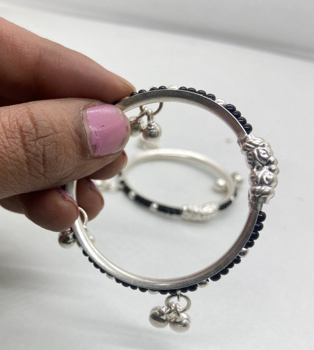 Pushker Badri Sarraf Black Beads with Trinklets - Pure Silver Baby Bracelets/Kada (Set of 2) - KADA-BKBDT-S