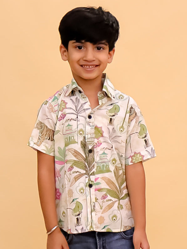 Child wearing a patterned shirt and jeans on a beige background