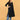 Pregnant model posing in black maternity kurta styled with blue pants and white sneakers.