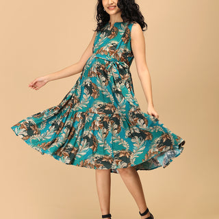 Woman twirling in teal tiered floral maternity and nursing dress