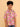 Child wearing a colorful patterned shirt and jeans on a beige background