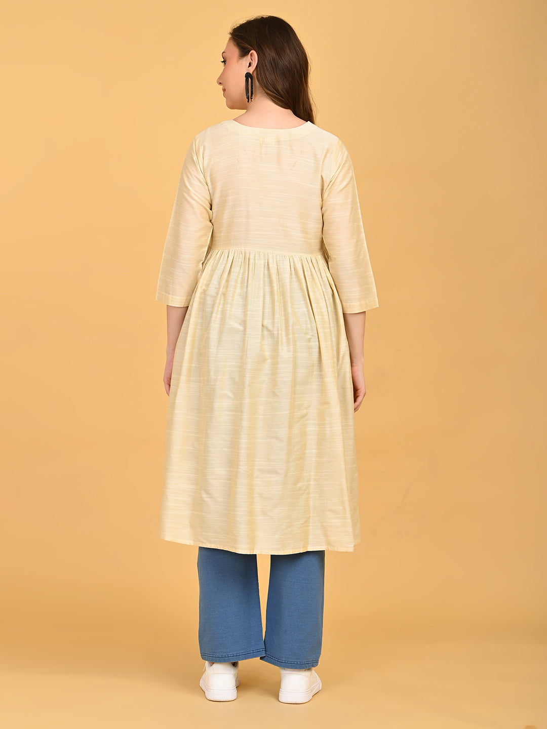 Back view of cream maternity silk kurta showing gathered waist and knee-length relaxed silhouette.