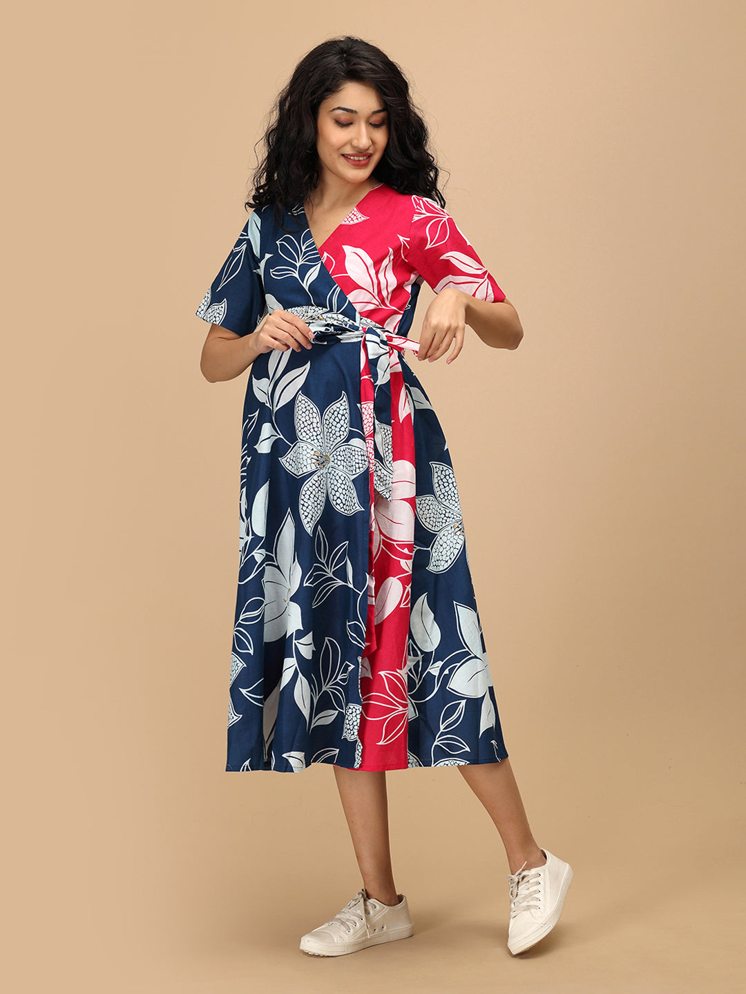 Side angle of The Mom Store Dual Bloom maternity and nursing wrap dress with pockets and tie belt.