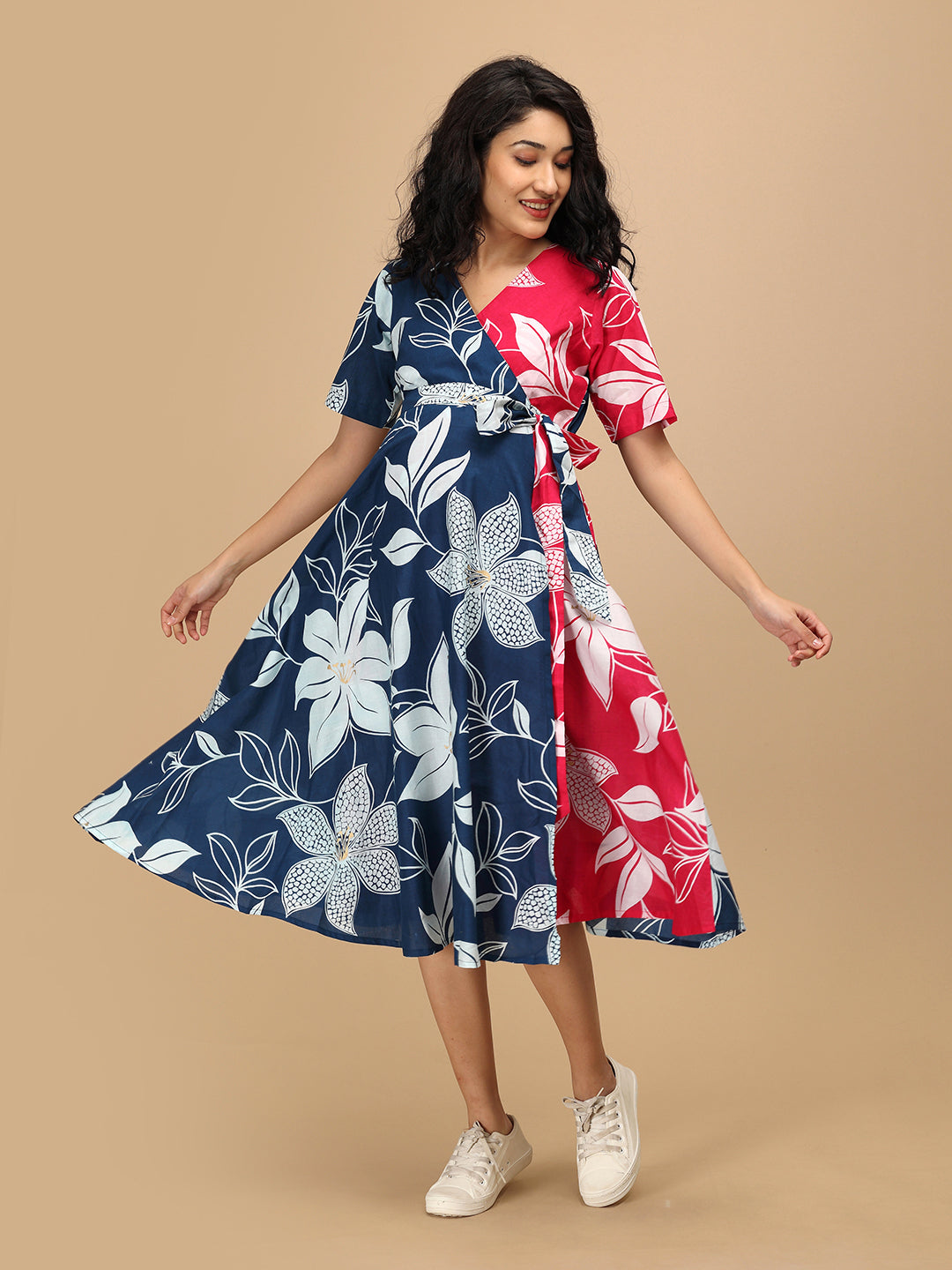 Twirling pose in The Mom Store Dual Bloom maternity and nursing wrap dress with large floral prints.