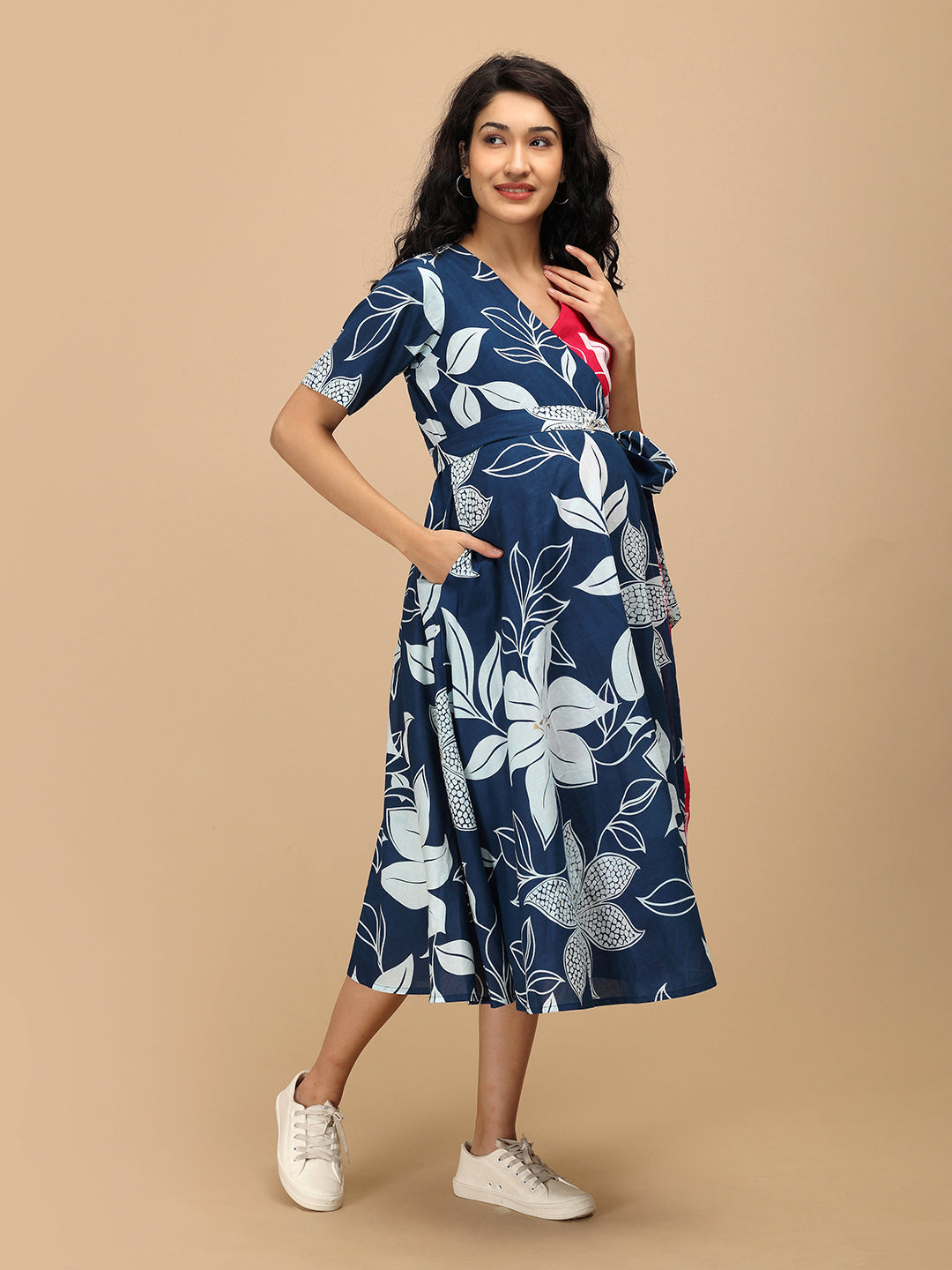 Side pose of The Mom Store Dual Bloom maternity wrap dress showing tie-up waist detail.