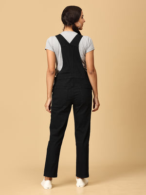 back view of pregnant woman in The Mom Store black Denim Maternity Dungaree with Side Buttons 