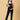 Front view of a Model posing with her hand on pregnant belly in The Mom Store black Denim Maternity Dungaree with Side Buttons 