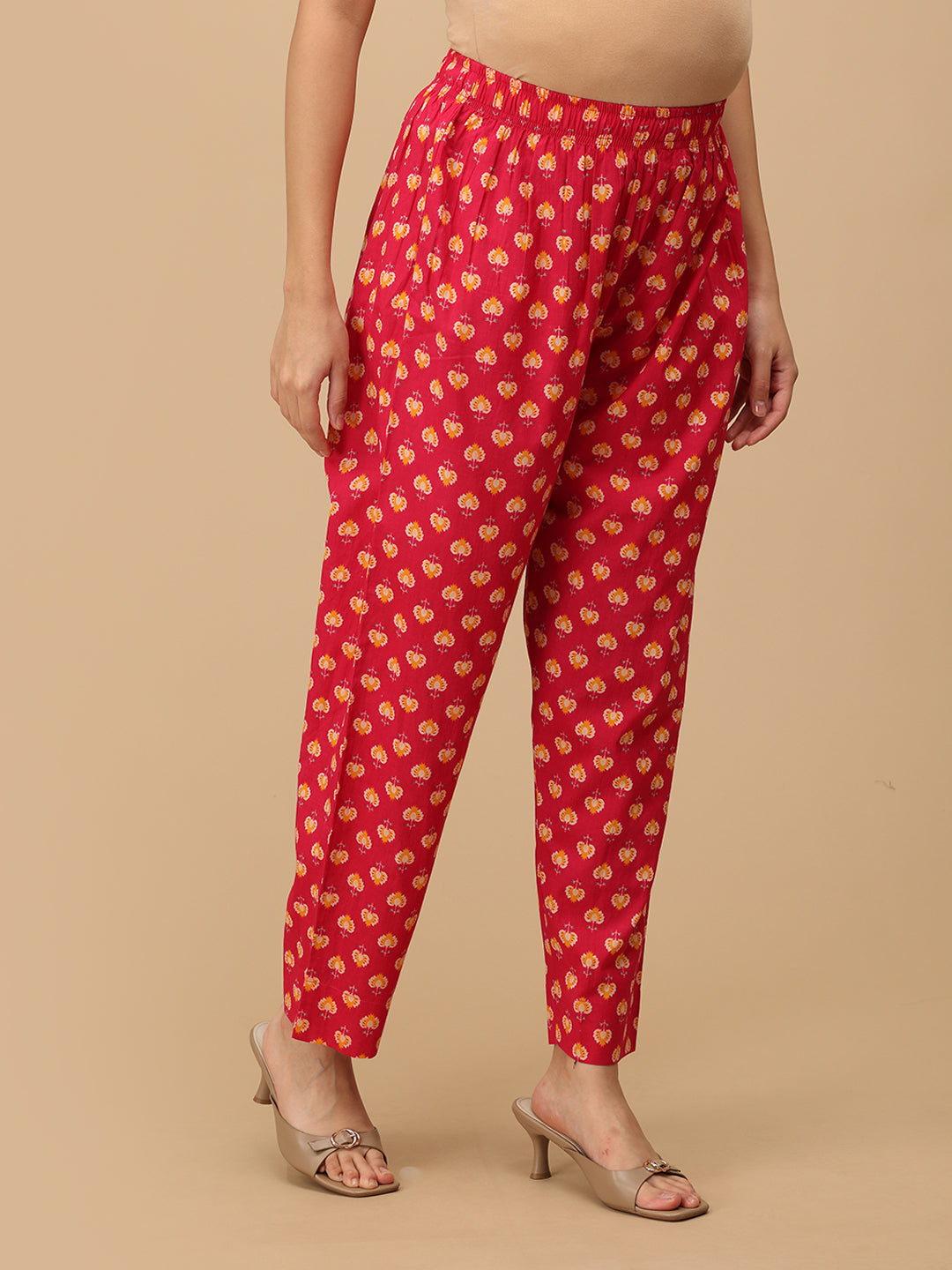 side view of printed pink straight-fit maternity pants with an elasticated waistband.