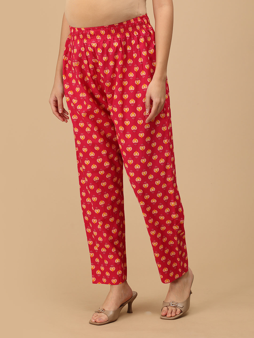 side view of printed pink straight-fit maternity pants with an elasticated waistband.