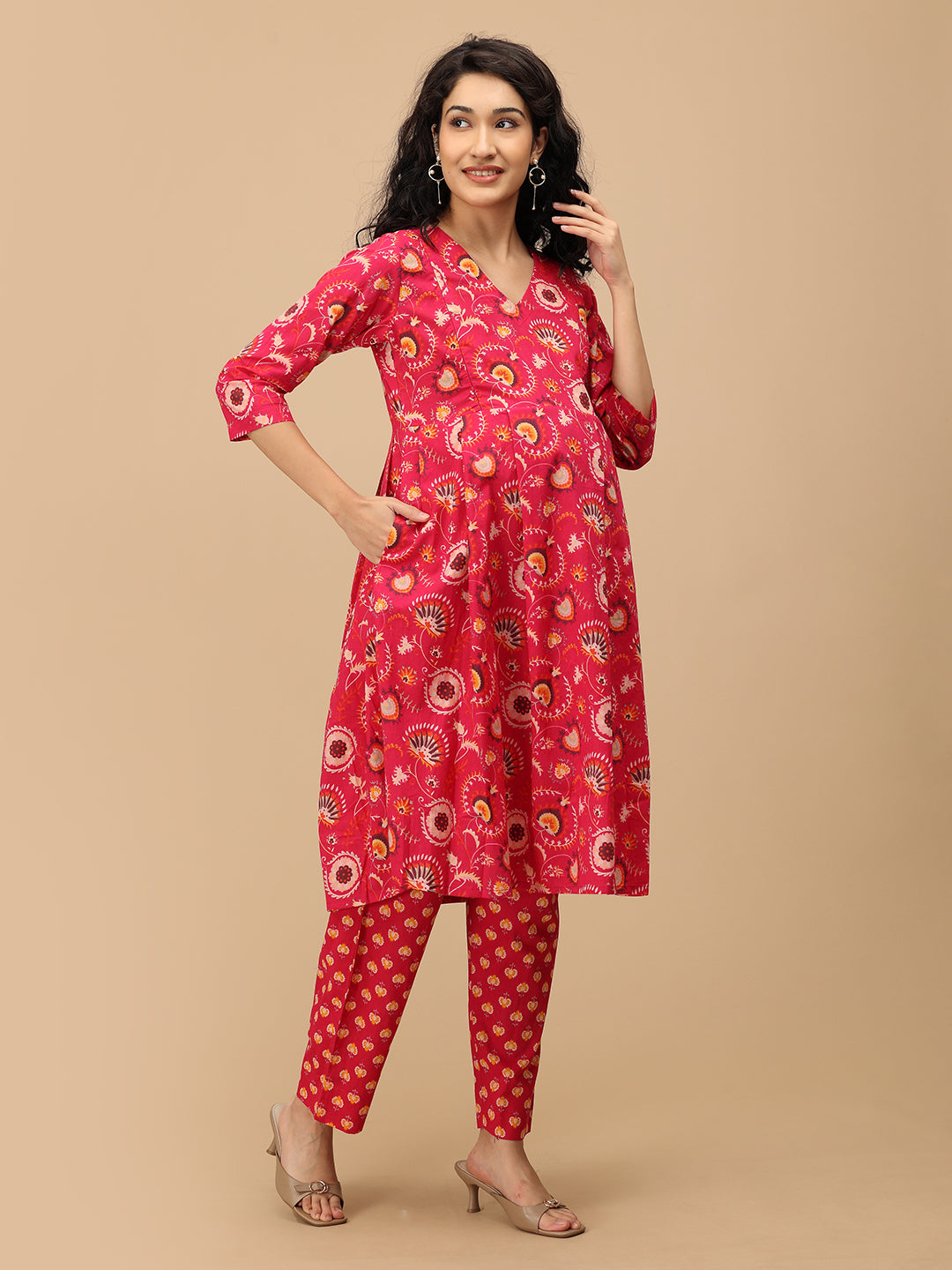 Side angle of the printed pink maternity pants showing the relaxed straight silhouette and comfortable fit.