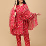 Angled front view of the printed pink maternity kurta paired with matching pants, model lightly touching her hair.