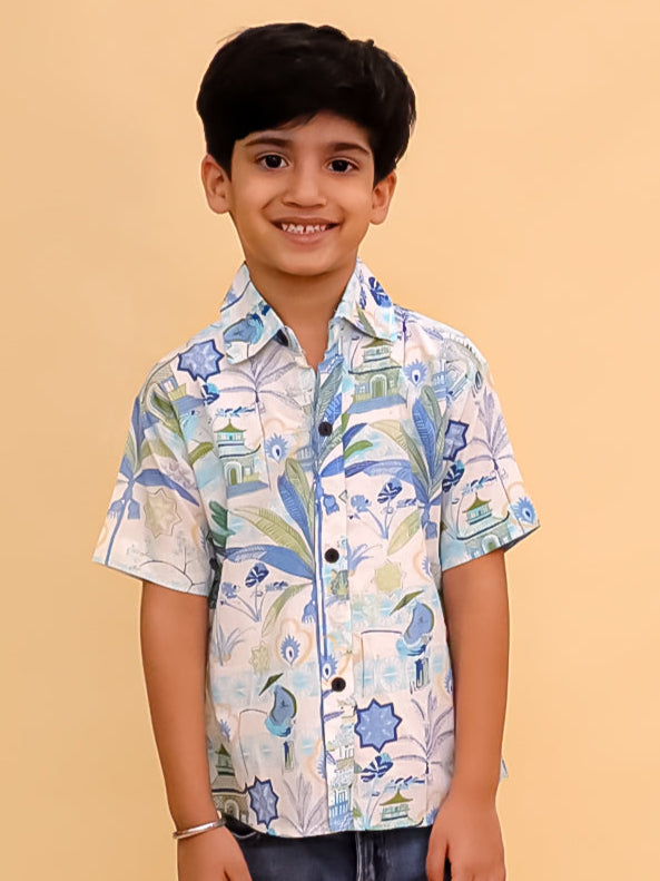 Child wearing a patterned shirt and jeans on a beige background