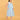 Pregnant model wearing blue and white striped sleeveless maternity dress with V-neckline and knee-length silhouette.