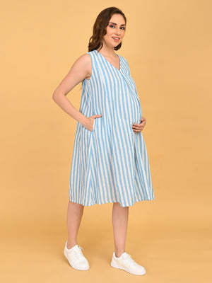 Pregnant model wearing blue and white striped sleeveless maternity dress with V-neckline and knee-length silhouette.