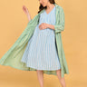Front view of Stripe Duet maternity and nursing dress paired with open green striped shacket.