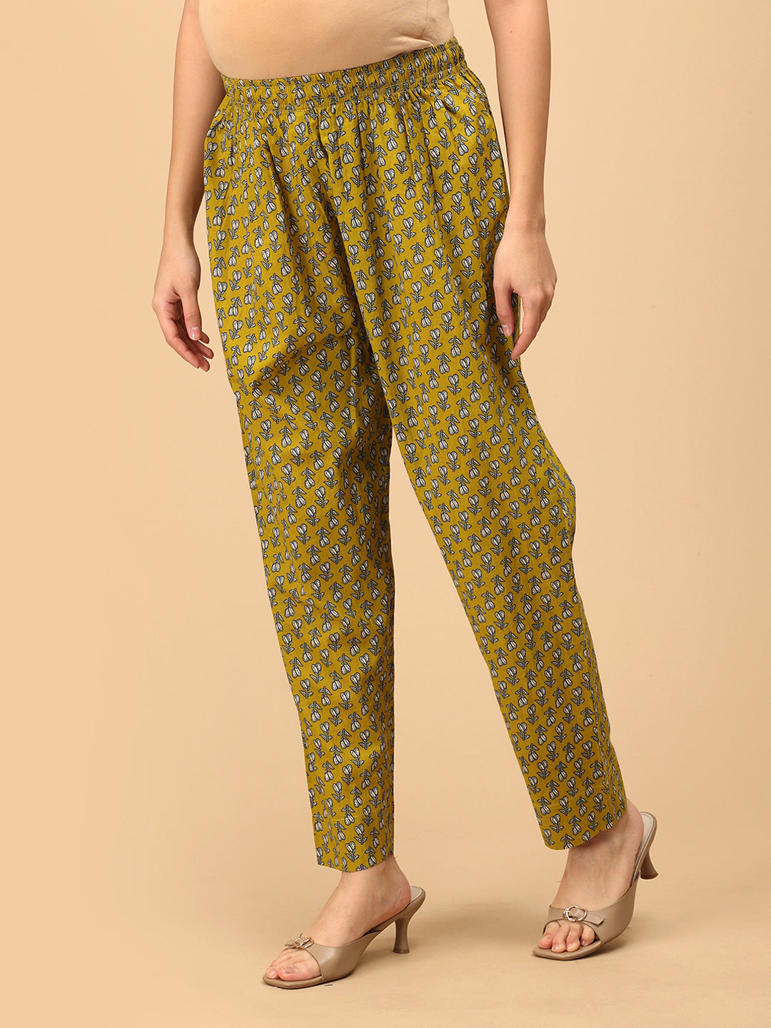 Side angle of Sunehri Blooms yellow printed maternity pants with relaxed straight-leg silhouette.