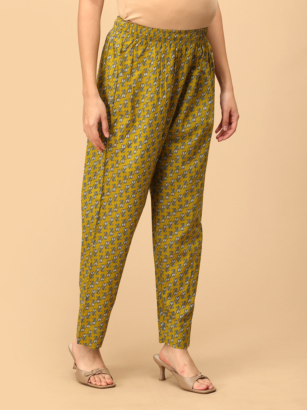 Side angle of Sunehri Blooms yellow printed maternity pants with relaxed straight-leg silhouette.