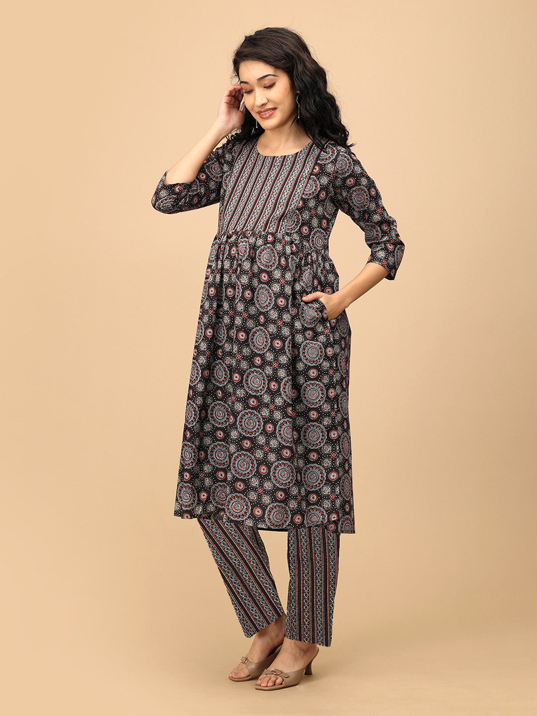 Front pose of the model in The Ajrakh Edit black printed maternity and nursing kurta with matching straight pants.