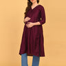 Pregnant model wearing wine maternity and nursing silk kurta paired with blue straight-fit pants and white sneakers.