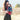 Mother holding baby close in Almitra Tattva Kullu-inspired ergonomic baby carrier featuring bold tribal weave patterns in red, turquoise, black, and ochre tones, designed for inclusive babywearing, hands-free comfort, and secure front carry support outdoors.