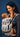 Side profile of a smiling mother and her baby in the Almitra Tattva Ajrakh carrier, emphasizing the padded shoulder straps, side adjustment buckles, and the folded head support panel.