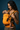 Side profile view of a mother smiling down at her baby resting securely in the bright yellow patterned Ikkat baby carrier.