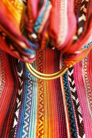 Close up detail of Almitra Tattva Larona Wrap Converted Ring Sling showing premium woven bohemian textile, dual sling rings, soft breathable fabric, and secure ergonomic baby carrier craftsmanship.