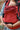 Front view of Almitra Tattva ergonomic baby carrier in bold red print with secure buckles and soft padded support, designed for mindful and inclusive babywearing.