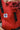 Close-up of Almitra Tattva red printed baby carrier featuring breathable fabric, ergonomic structure, adjustable black straps, and soft support for comfortable babywearing.