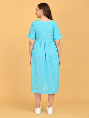 Back view of Aquamarine Affair Maternity and Nursing Dress with geometric print, short sleeves, and relaxed midi silhouette.