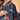 Close-up of concealed side zipper on blue floral maternity dress for easy nursing access.
