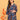 Pregnant model posing in blue floral maternity and nursing dress while holding decorative orange leaves.