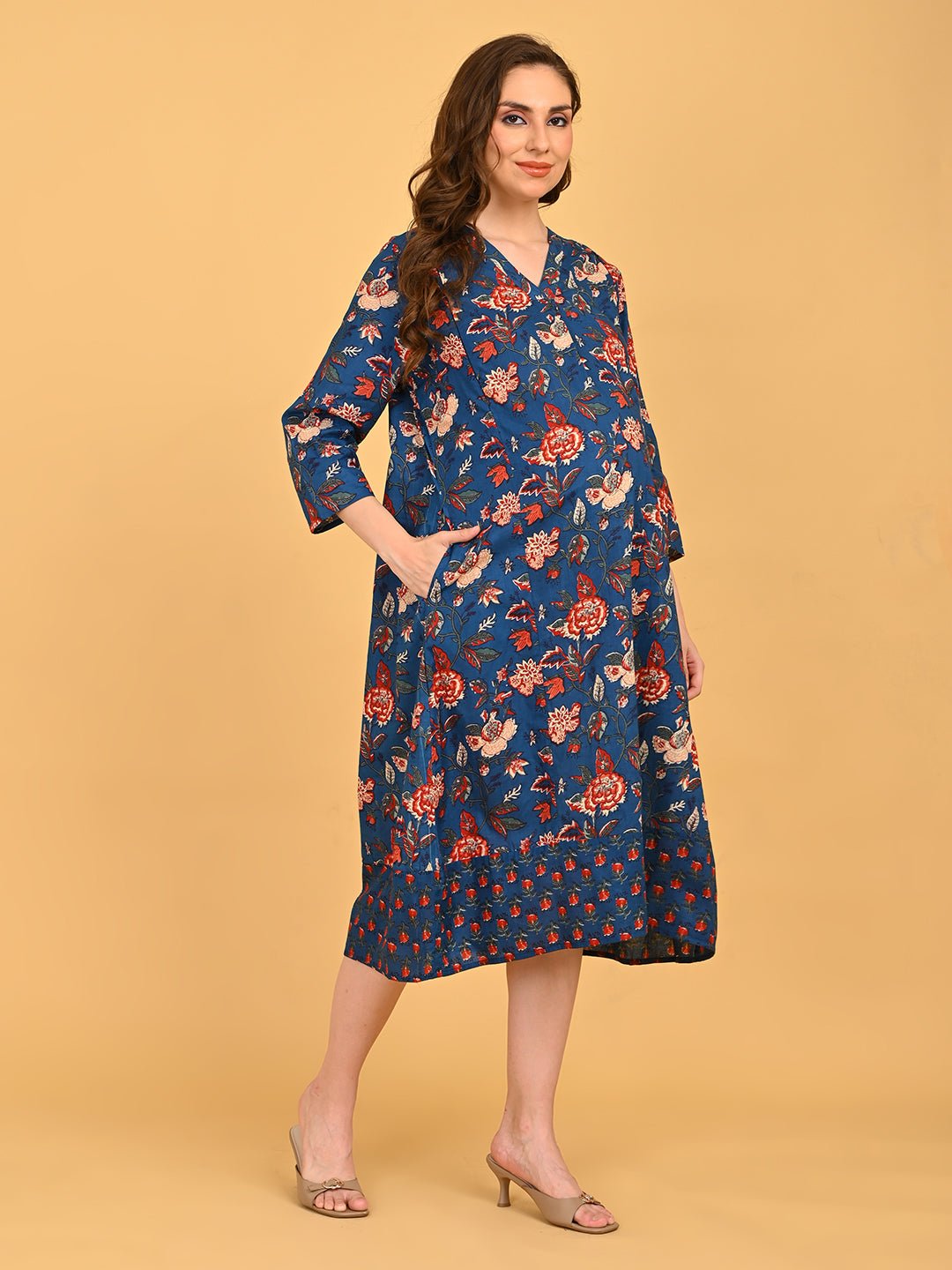 Side view of blue floral maternity dress showing bump-friendly A-line shape and mid-calf length.