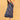 Pregnant model posing in blue floral maternity and nursing dress while holding decorative orange leaves.