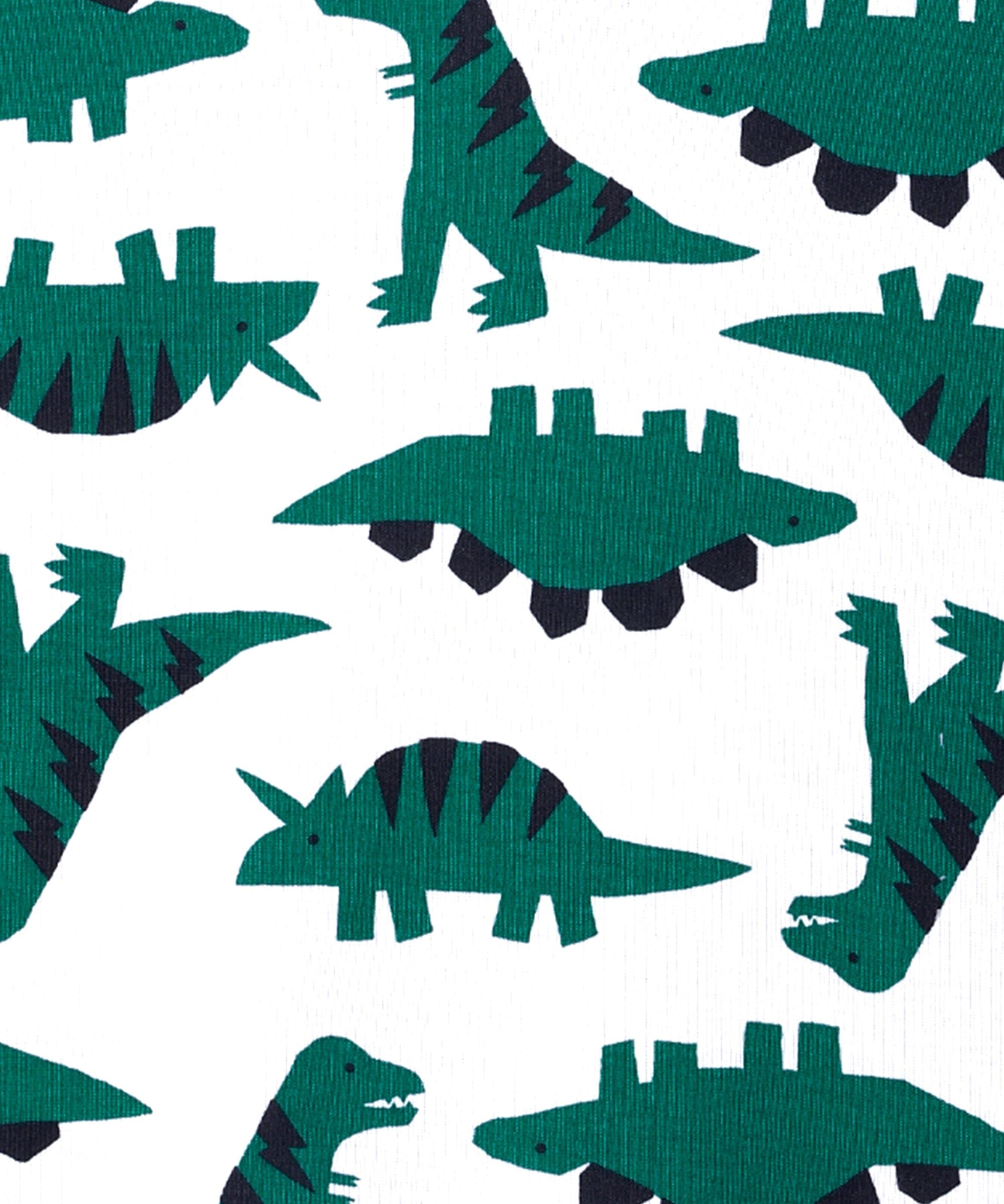 Detailed fabric close-up of The Mom Store Dreamasaurus cotton material showing green dinosaur motifs.