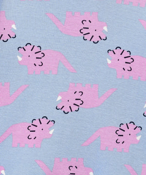 Close-up of the The Mom Store Roar & Rest Pajama Set fabric showing pink dinosaur print on soft blue cotton.
