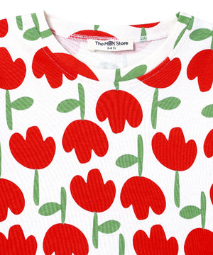 Neckline close-up of The Mom Store Tulip Twinkle pajama top showing the brand tag and red tulip print.