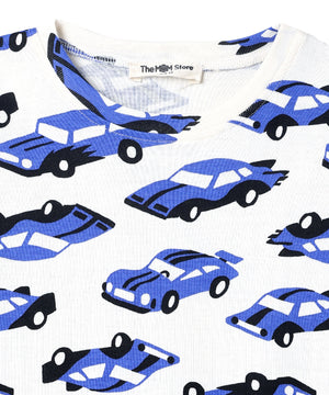 Neckline close-up of The Mom Store Zoomy Dreams pajama top showing brand tag and car print details.