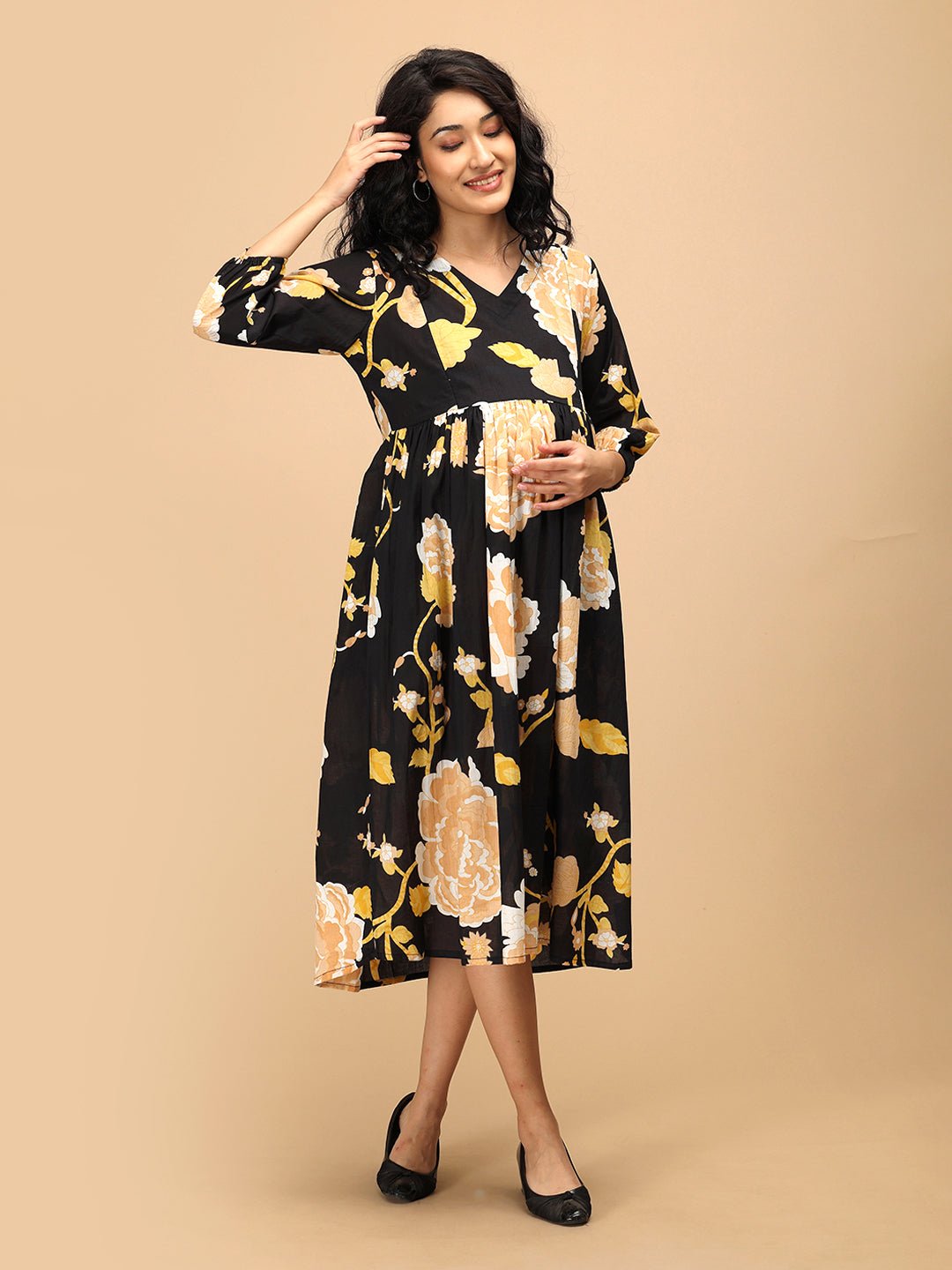 Comfort-fit maternity dress in black with peony floral print and 3/4 sleeves.