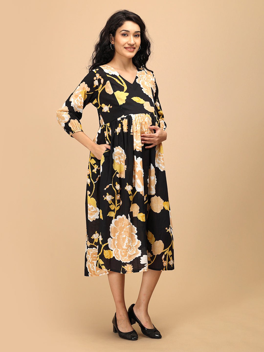 Side view of Black Peony maternity wear dress featuring yellow floral pattern and pockets.
