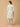 Woman wearing a floral dress on a beige background