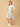 Woman wearing a floral dress on a beige background