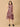 Woman wearing a sleeveless floral dress on a beige background