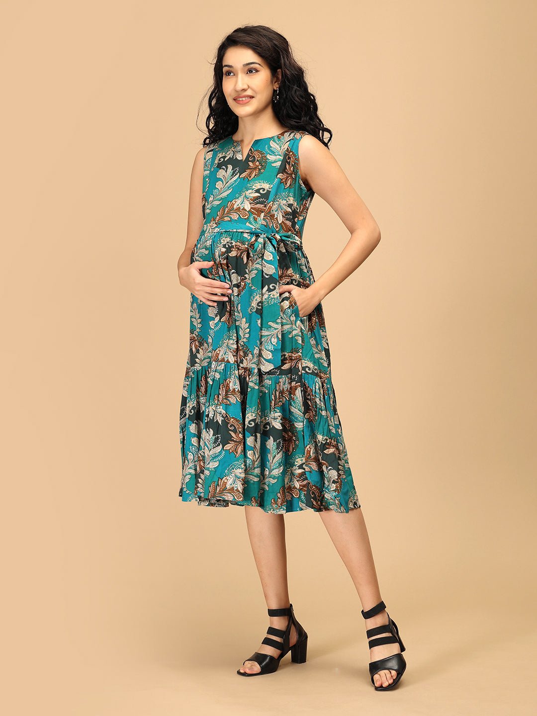 Side view of teal floral maternity dress with nursing access and pocket detail