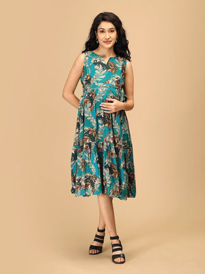 Woman wearing teal floral maternity and nursing dress with tie-up waist and tiered hem