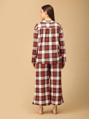 Pregnant model wearing Check Me In Maternity and Nursing Pajama Set from the mom store facing backwards