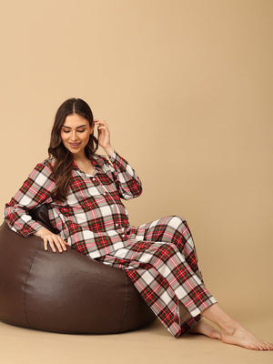 Pregnant model wearing Check Me In Maternity and Nursing Pajama Set from the mom store sitting on a bean bag
