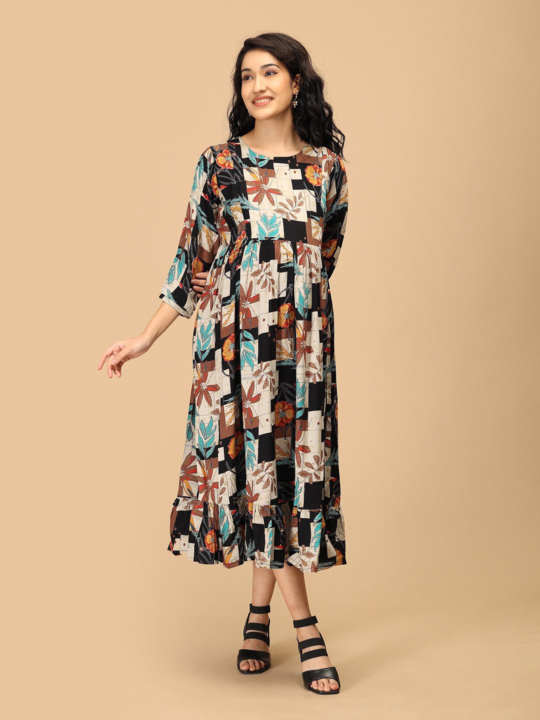 Pregnant woman in The Mom Store Chic Collage maternity and nursing dress with floral patchwork print.