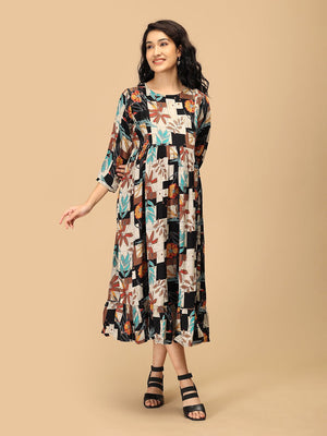 Pregnant woman in The Mom Store Chic Collage maternity and nursing dress with floral patchwork print.