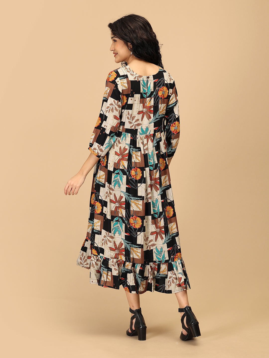 Back view of The Mom Store Chic Collage maternity dress with ruffle hem and multicolor block print.